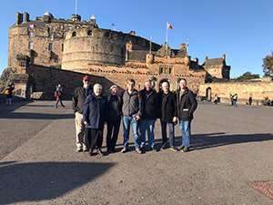 group of people standing in front of a castle
