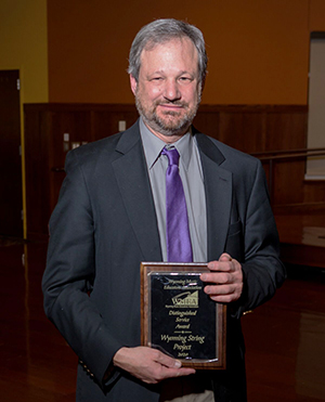 man holding an award