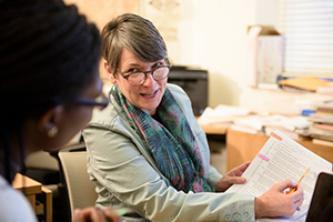 woman pointing to information on papers