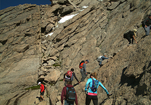 people climbing a rocky mountainside