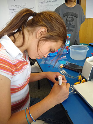 young woman working on a project at a table