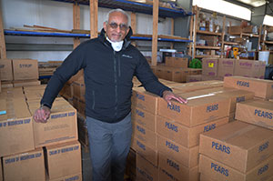 man standing amid stacks of boxes