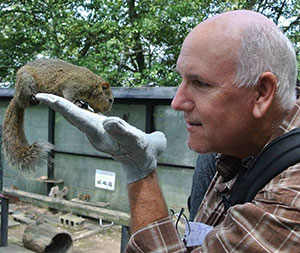 man with a squirrel perched on his hand