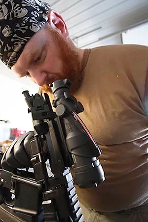 man working with a gun scope