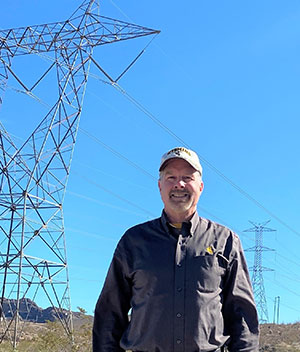 man standing in front of power lines