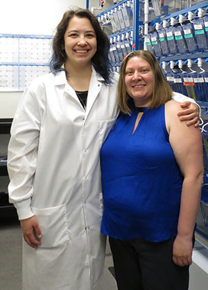 two people standing together in a lab