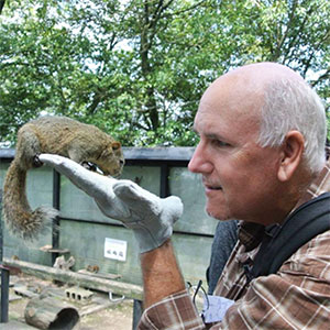 man with a squirrel on his hand