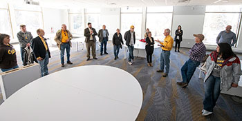 a group of people standing in a large room