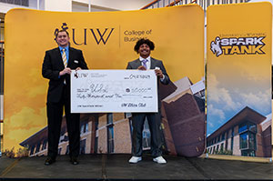 two people holding an oversized check