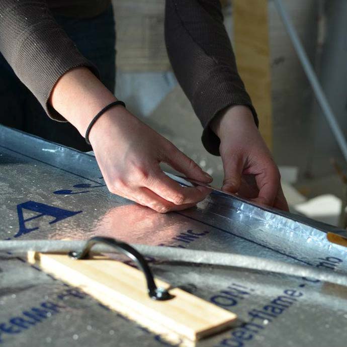 students measuring insulation panels during barn construction