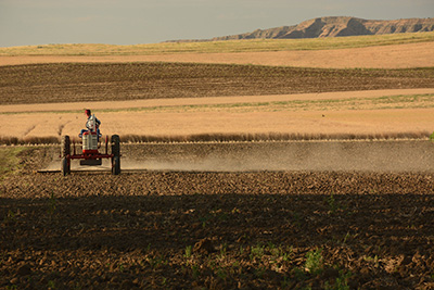 Man on tractor plowing up field in the fall.