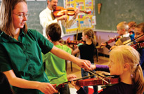 Ruth Jacobs, a senior music education major, helps teach the violin to local students.