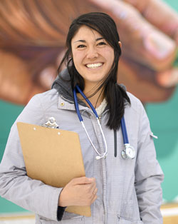 woman with stethoscope carrying a clipboard
