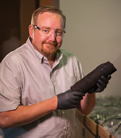 man holding a cylindrical item