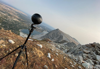 equipment on a tripod with mountains in the background