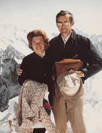 woman and man posing outside in snowy mountains