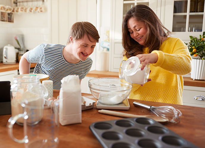 young man and woman making cookies