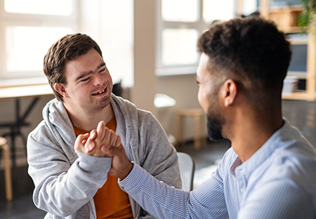 person with a disability shaking hands with another person