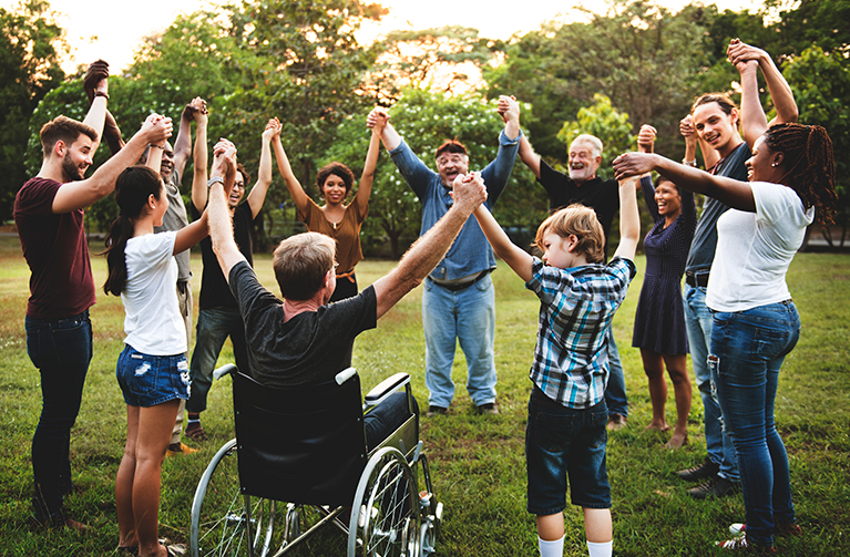 group of people of all abilities gather in a circle