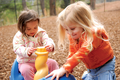 two young girls playing outside