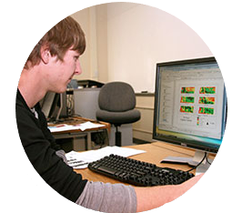 Student looks at remote sensing data on a computer screen.