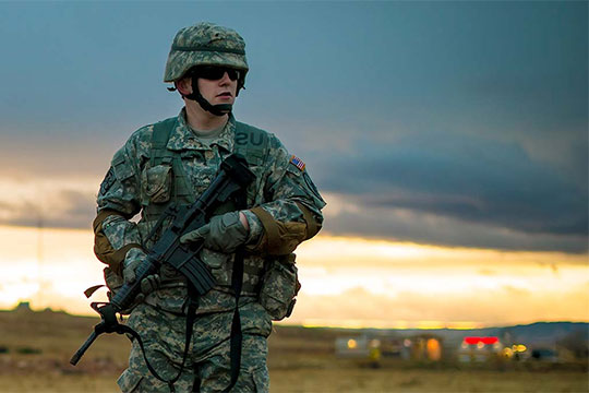Soldier walking at sunset