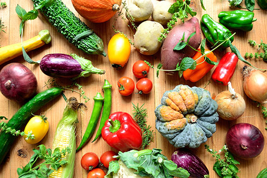 a variety of colorful vegetables on a wooden cutting board