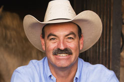Male volunteer with mustache in a cowboy hat