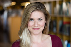 Young blonde woman wearing a maroon blouse