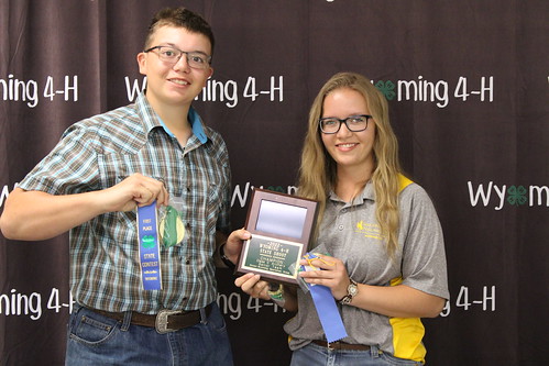 boy and girl holding ribbons and plaque