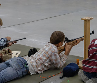 boy taking aim in prone position