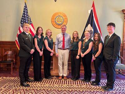 7 youth leadership team members at the Wyoming Capital Building with Governor Mark Gordon.