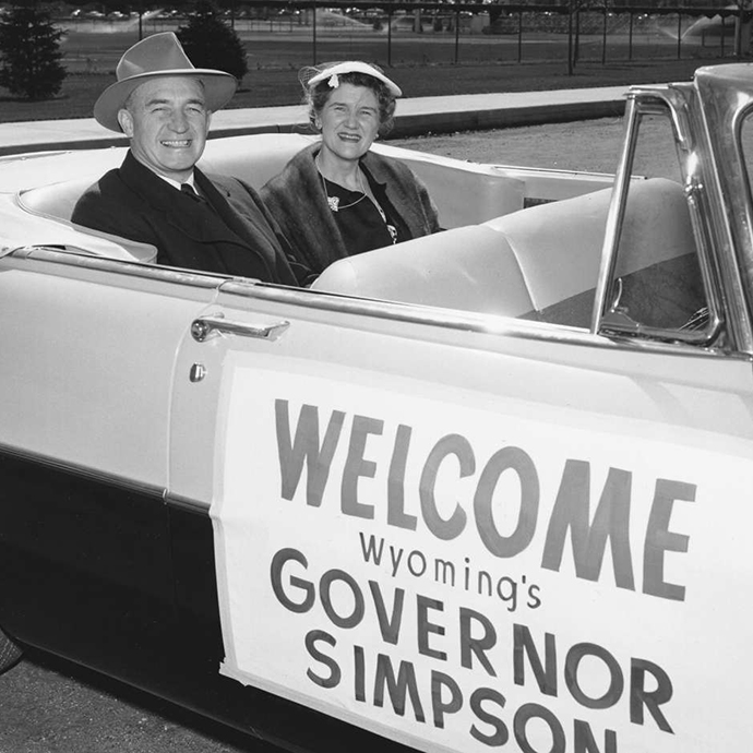 governor milward simpson driving with his wife and waving to SPPAIS students