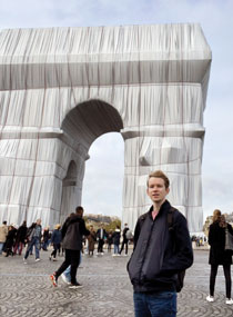person standing in front of a marble arch