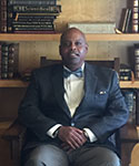 Dr. Fredrick Douglass Dixon sitting in a chair.