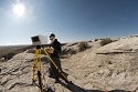 A visual Geology tool and person using it out in the rocky prairie