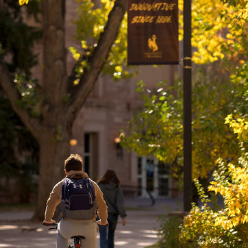 Student riding bike towards Union
