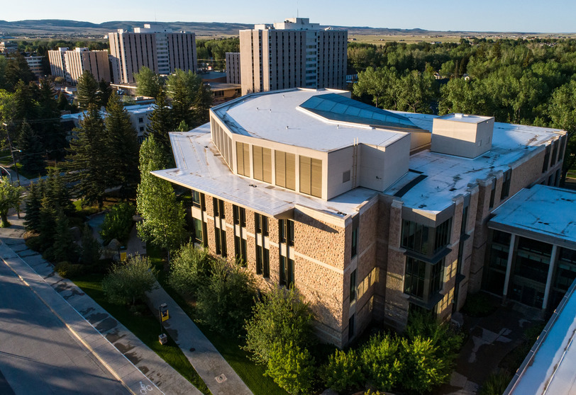 An aerial exterior of a nice college building among trees.