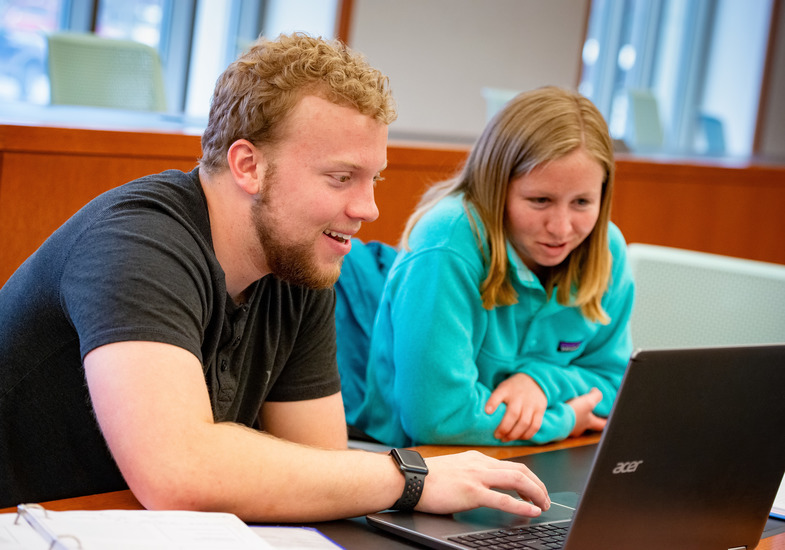 two students in a college of business classroom