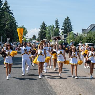 Cheer leaders walking down the street during the Jubilee Days in Laramie