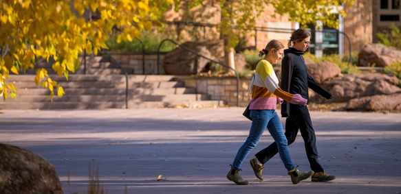Two UW students walk together on the University of Wyoming campus.