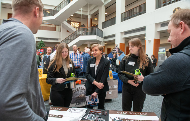 Students and employers speaking at the College of Business Career Fair in the Jonah Bank Atrium
