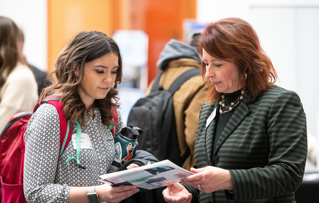 Student and employer speaking at a College of Business career fair