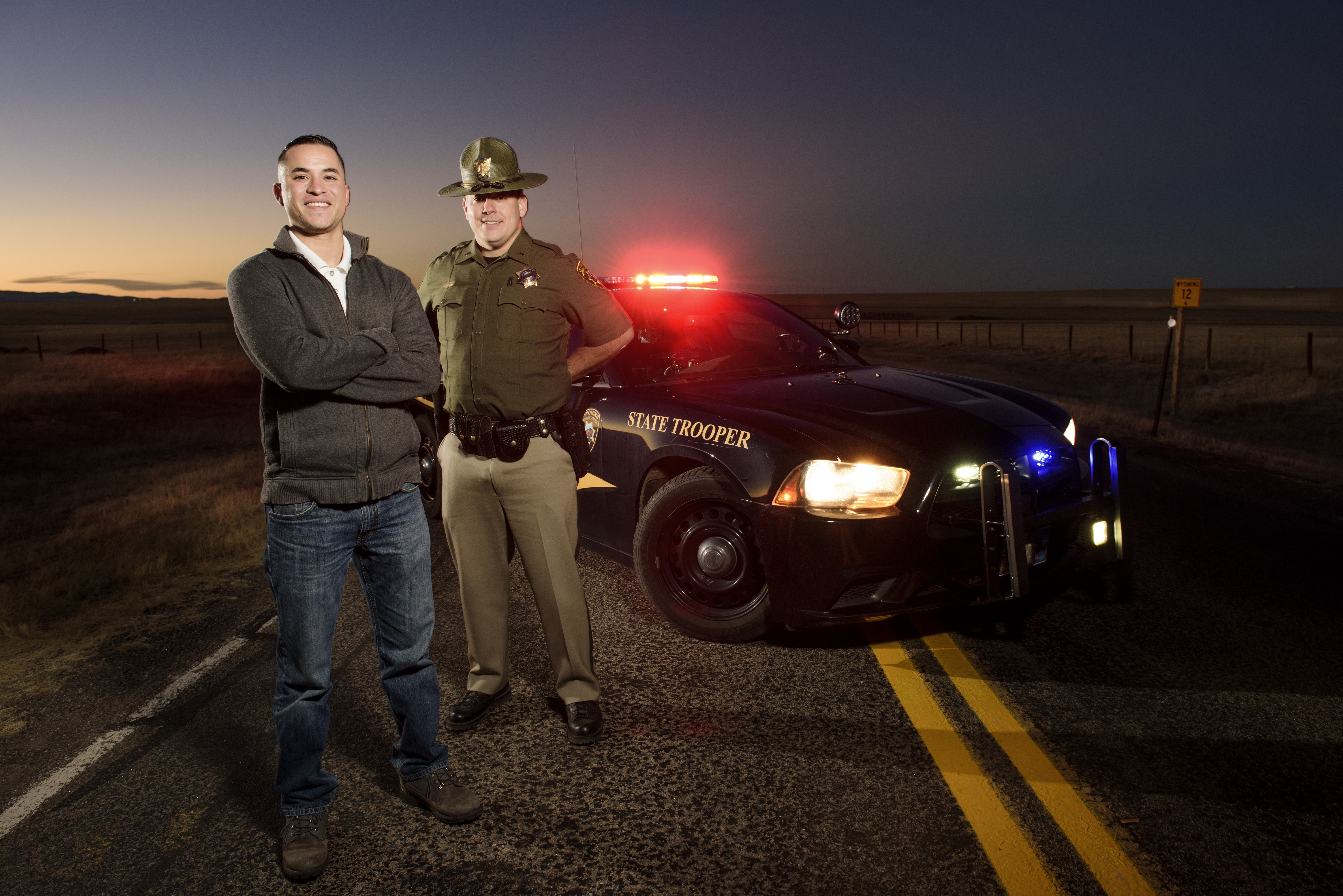 criminal justice stuent standing with a highway patrol officer