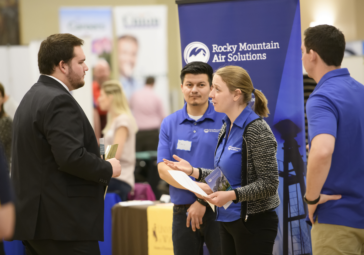 student speaking with an employer at the job fair
