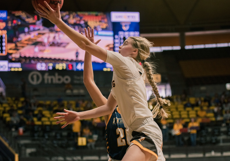 A Wyoming Cowgirl basketball player going to a lay-up in a game.