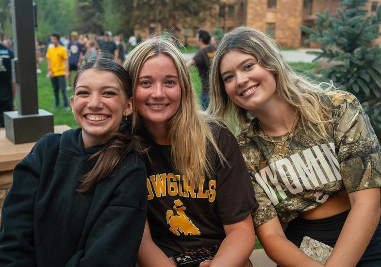 three friends sitting in Prexy's during Saddle Up
