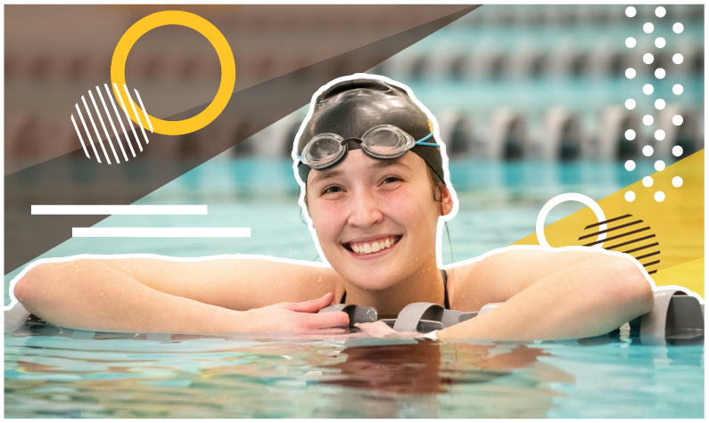 Student swimmer smiles at camera in pool while wearing googles and a swim cap