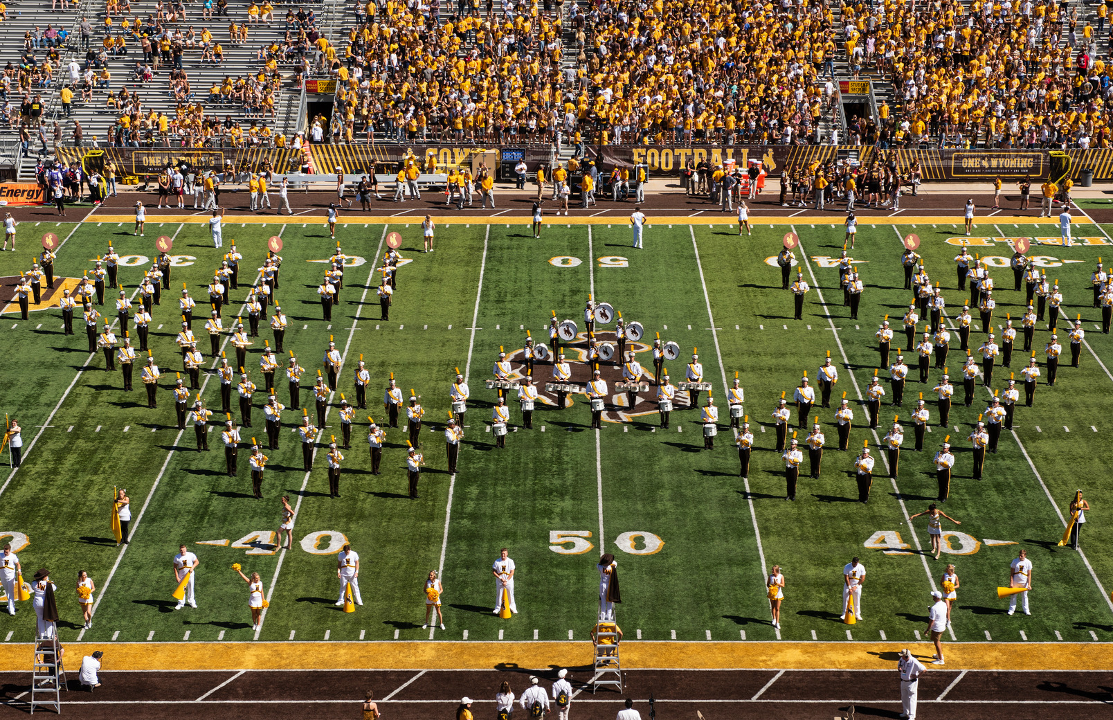 western thunder marching band arranged in a W formation on the football feild
