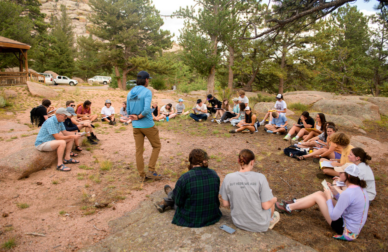 Haub School students having a lesson outside